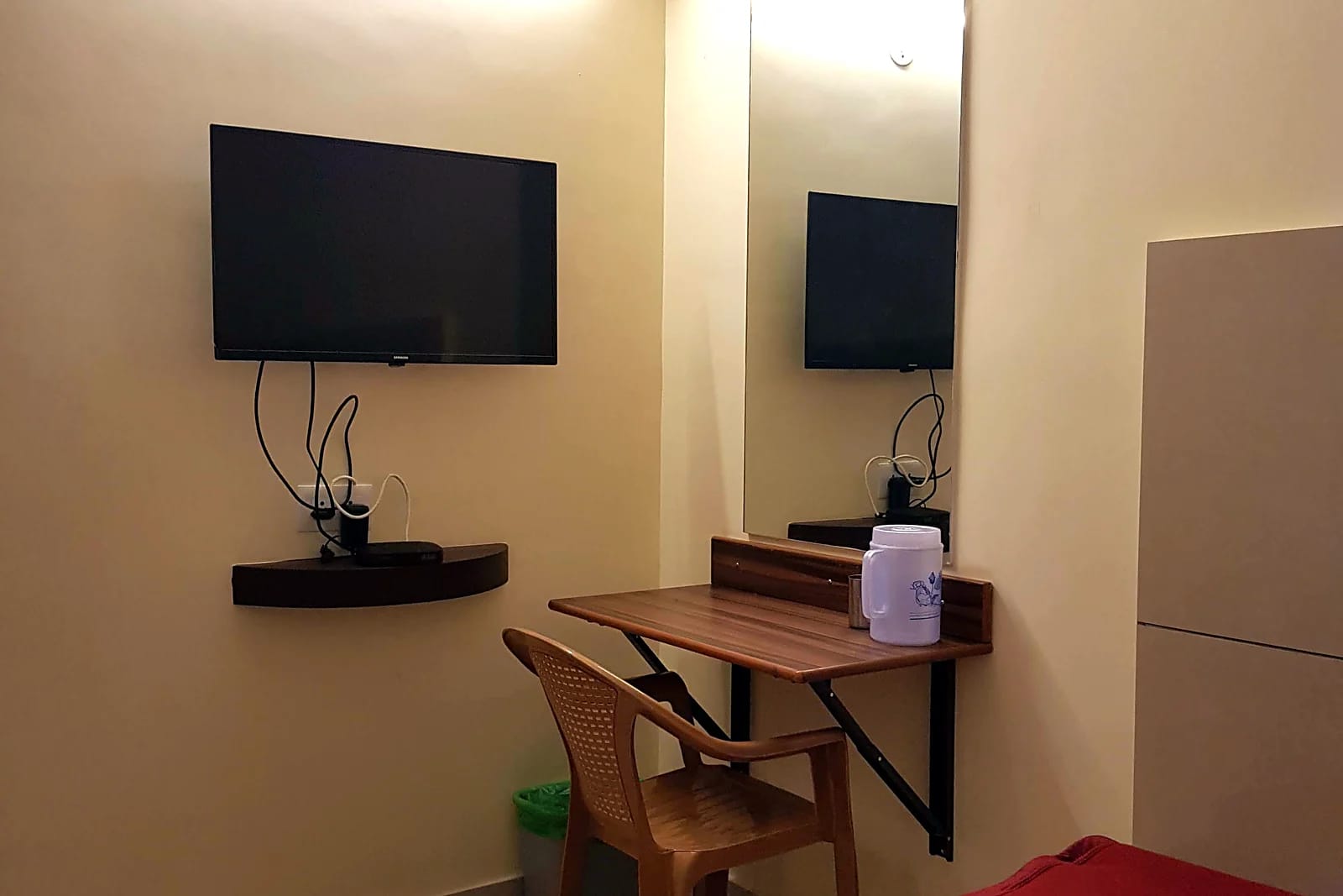 Nisarga Inn Grand — Desk and TV