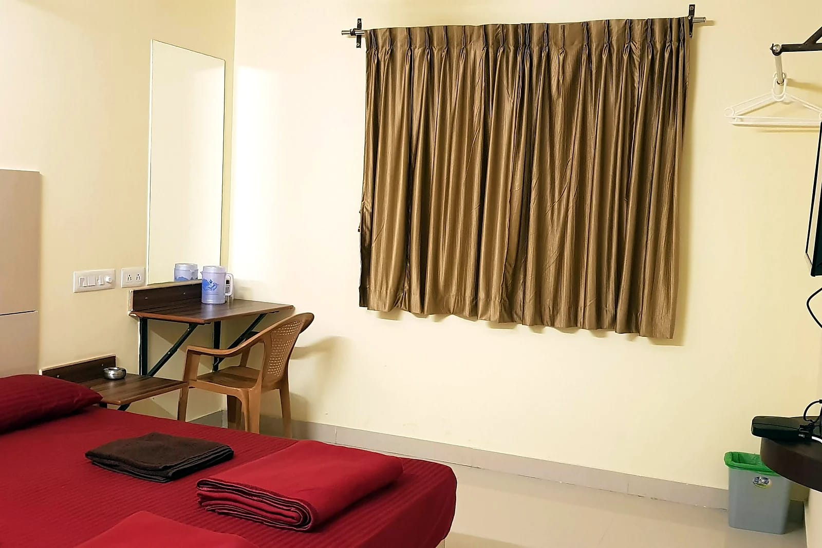 Nisarga Lodge — Room with desk and TV (representative photo)