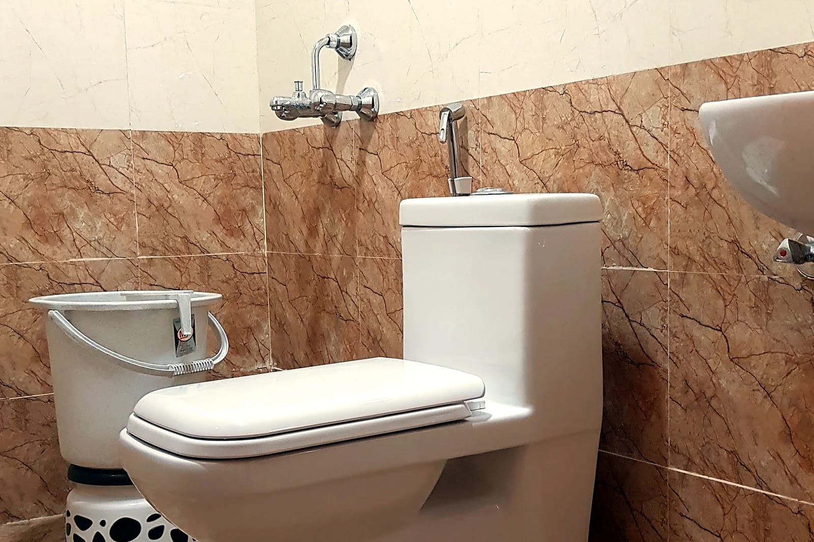 Nisarga Lodge — Attached bathroom (representative photo)